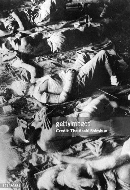 Atomic bomb survivors lie on the floor, waiting for receive treatment at temporary hospital set at Fukuya Department Store in August 1945 in...
