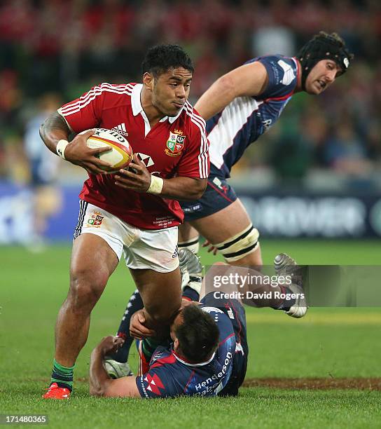 Manu Tuilagi of the Lions is tackled by Nic Henderson during the International Tour Match between the Melbourne Rebels and the British & Irish Lions...