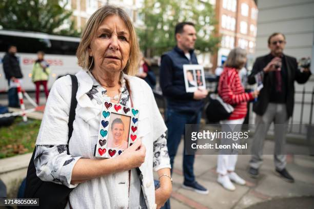 Woman holds a framed photograph of her mother, who died during the pandemic, ahead of the first day of the second phase of the UK Covid-19 public...