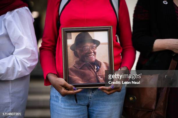 Jean Adamson holds a photograph of her father Aldrick Adamson, who died during the pandemic, ahead of the first day of the second phase of the UK...