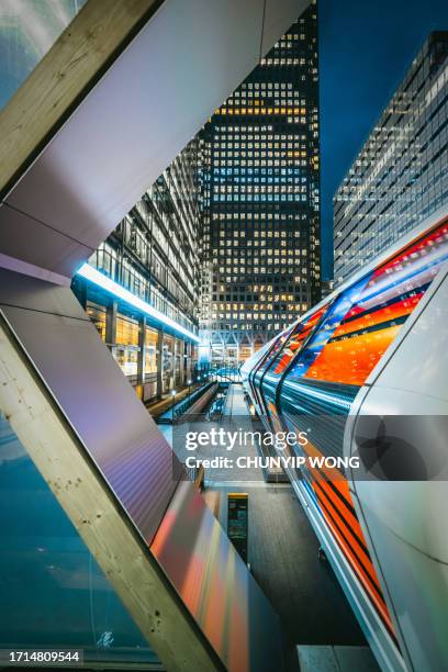 modern footbridge in canary wharf at night, london, england - crossrail stock pictures, royalty-free photos & images