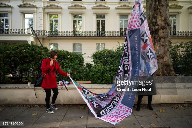Relatives erect a banner ahead of the first day of the second phase of the UK Covid-19 public inquiry at Dorland House on October 03, 2023 in London,...