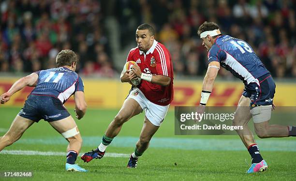 Simon Zebo of the Lions takes on Mitch Inman and Lachlan Mitchell during the International Tour Match between the Melbourne Rebels and the British &...