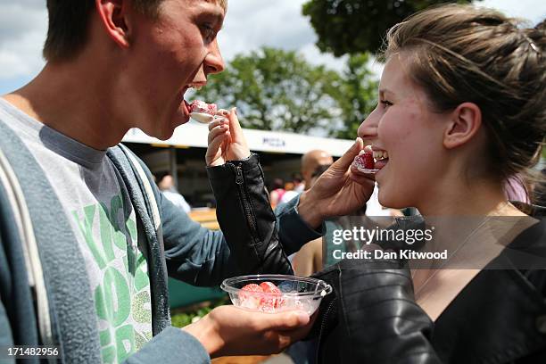 Tennis fans enjoy strawberries and cream on day two of the Wimbledon Lawn Tennis Championships at the All England Lawn Tennis and Croquet Club on...