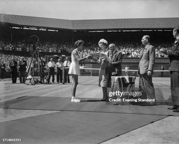 Brazilian tennis player Maria Bueno receiving her trophy from the Duchess of Kent after winning the women's singles final at the Wimbledon Tennis...