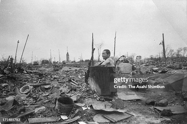 Man take a bath at ruined Tokyo after the bombing of Tokyo in March 1945 in Tokyo, Japan.