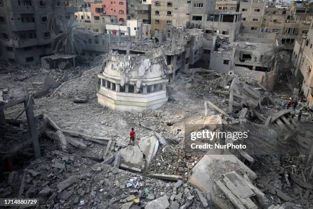 Palestinians inspect a mosque destroyed in Israeli strikes on Gaza City's Shati refugee camp early on October 9, 2023. The Israeli army said it hit...
