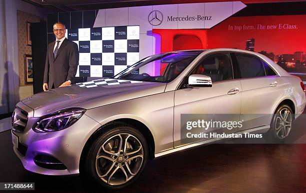 Managing director and Chief Executive Officer of Mercedes-Benz India Eberhard Kern poses with the newly launched E Class model of Mercedes-Benz on...