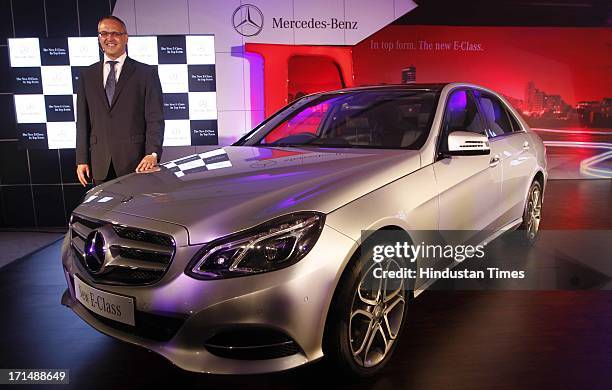 Managing director and Chief Executive Officer of Mercedes-Benz India Eberhard Kern poses with the newly launched E Class model of Mercedes-Benz on...