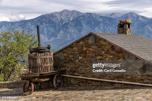 wine press and house in front of mt. canigou. jujols, occitania, france. - canigou stock pictures, royalty-free photos & images