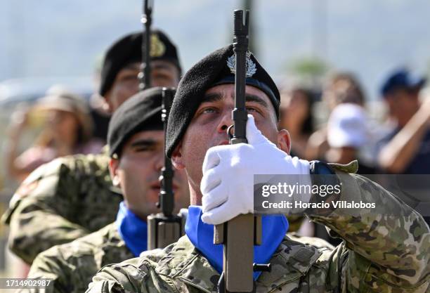 Members of the military honor guard stand at attention while singing Portuguese national anthem during the welcome ceremony in which the President of...