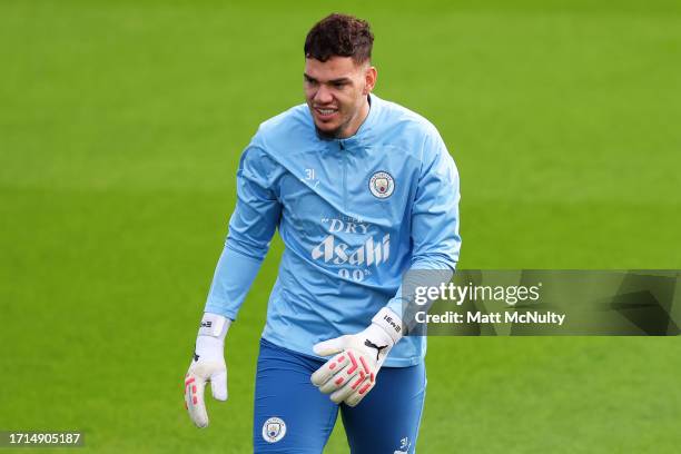 Ederson of Manchester City looks on during a training session ahead of their UEFA Champions League Group G match against RB Leipzig at Manchester...