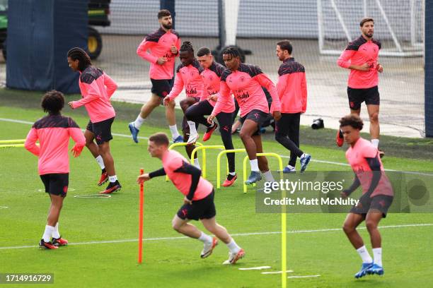 Manuel Akanji of Manchester City warms up with teammates during a training session ahead of their UEFA Champions League Group G match against RB...