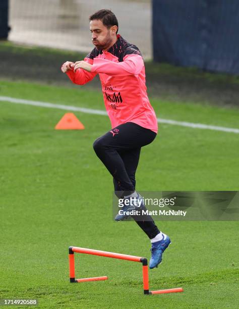 Bernardo Silva of Manchester City warms up during a training session ahead of their UEFA Champions League Group G match against RB Leipzig at...
