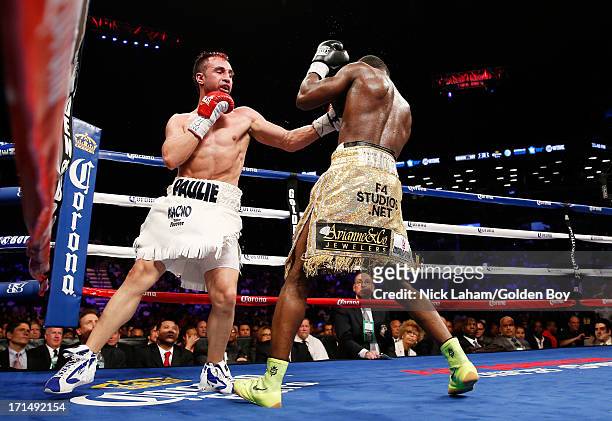 Paulie Malignaggi punches Adrien Broner during their WBA Welterweight Title bout at Barclays Center on June 22, 2013 in the Brooklyn borough of New...