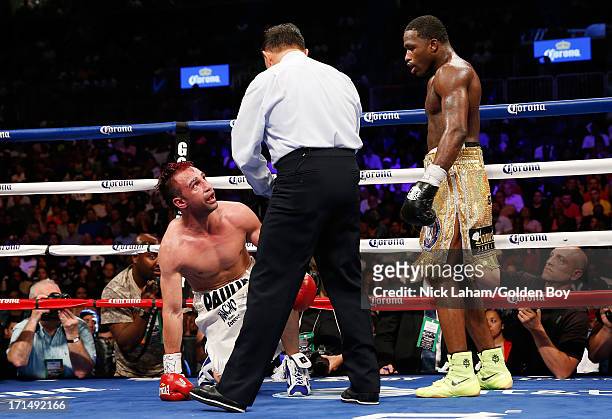 Adrien Broner knocks down Paulie Malignaggi during their WBA Welterweight Title bout at Barclays Center on June 22, 2013 in the Brooklyn borough of...