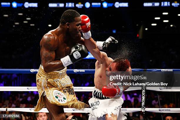 Paulie Malignaggi punches Adrien Broner during their WBA Welterweight Title bout at Barclays Center on June 22, 2013 in the Brooklyn borough of New...