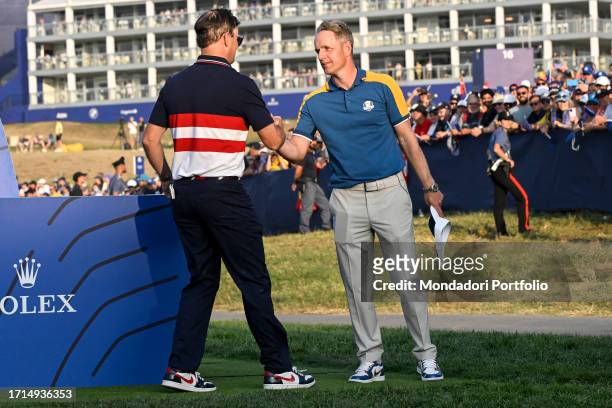 Team USA captain Zach Johnson and Team Eurppe captain Luke Donald greet each other during the 2023 Ryder Cup at Marco Simone Golf and Country Club....
