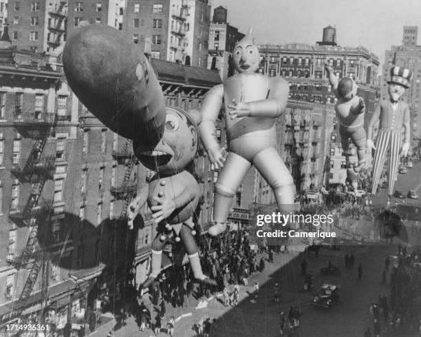 Macy's Thanksgiving Day parade in New York City, NY. A view from an office building in town. Large floats along the parade route.