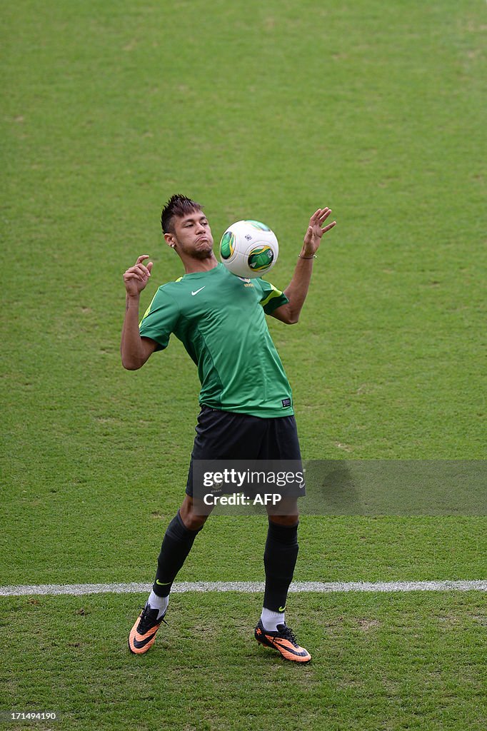 Brazil's forward Neymar controls the ball wih his chest during a
