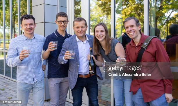 Ferenc Krausz and his team of the Max Planck Institute for Quantum Optics poses for photographers after co-winning the Nobel Prize in Physics on...