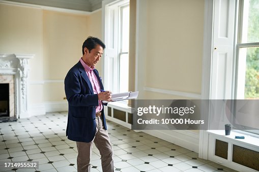 Architect making notes in empty property Architect making notes in empty property