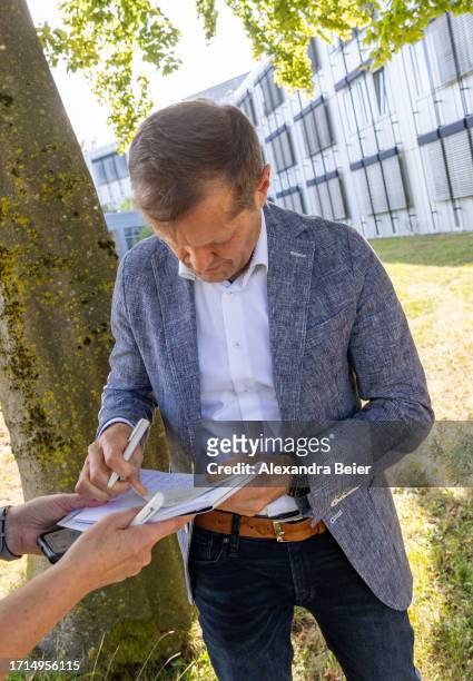 Ferenc Krausz signs an autograph in front of the Max Planck Institute for Quantum Optics after co-winning the Nobel Prize in Physics on October 03,...