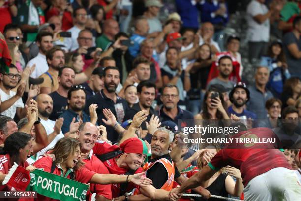 Portugal's lock Steevy Cerqueira celebrates with supporters after victory in the France 2023 Rugby World Cup Pool C match between Fiji and Portugal...