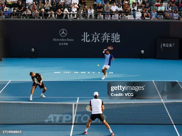 Ivan Dodig of Croatia and Austin Krajicek of the United States return a shot in the Men's Doubles Semi-final match against Santiago Gonzalez of...