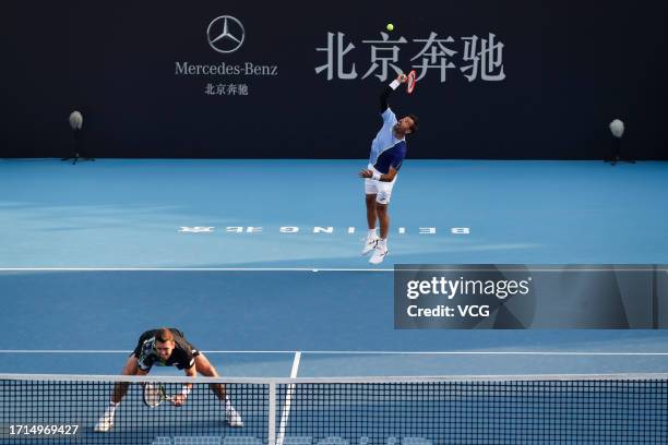 Ivan Dodig of Croatia and Austin Krajicek of the United States return a shot in the Men's Doubles Semi-final match against Santiago Gonzalez of...