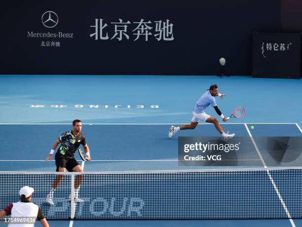Ivan Dodig of Croatia and Austin Krajicek of the United States return a shot in the Men's Doubles Semi-final match against Santiago Gonzalez of...