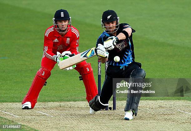 Brendon McCullum of New Zealand hits out as wicket-keeper Jos Buttler of England looks on during the 1st Natwest International T20 match between...