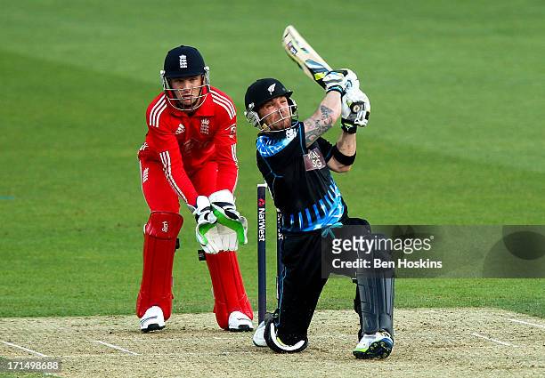 Brendon McCullum of New Zealand hits out as wicket-keeper Jos Buttler of England looks on during the 1st Natwest International T20 match between...