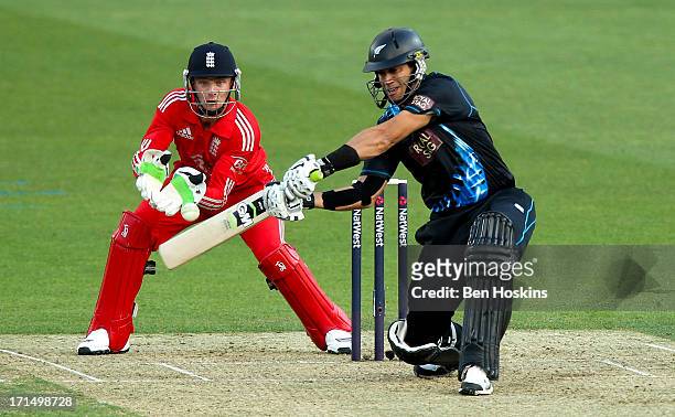 Ross Taylor of New Zealand hits out as wicket-keeper Jos Buttler of England looks on during the 1st Natwest International T20 match between England...
