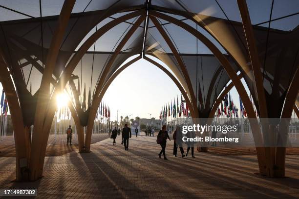 Attendees arrive at the event campus on the opening day of the annual meetings of the International Monetary Fund and World Bank in Marrakesh,...