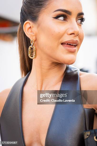 Camila Coelho wears a brown leather vest dress wand Louis Vuitton gold earrings, outside Louis Vuitton, during the Womenswear Spring/Summer 2024 as...