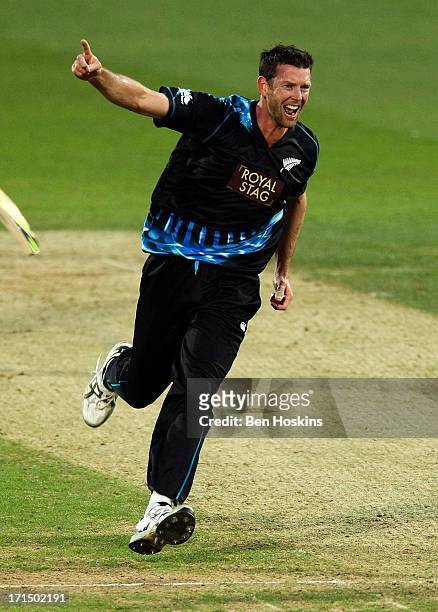 Ian Butler of New Zealand celebrates after taking the wicket of Eoin Morgan of England during the 1st Natwest International T20 match between England...