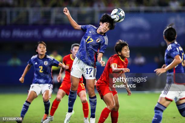 Wang Shuang of Team China and Koga Toko of Team Japan compete for the ball in the Football - Women's Semi-final match between China and Japan on day...