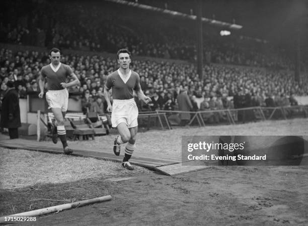 English footballer Jimmy Greaves , a forward with Chelsea FC, running onto the pitch on the day of a match at Stamford Bridge stadium in London,...