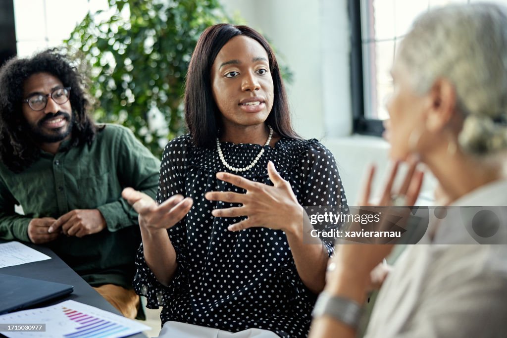 Colleagues debating during business meeting