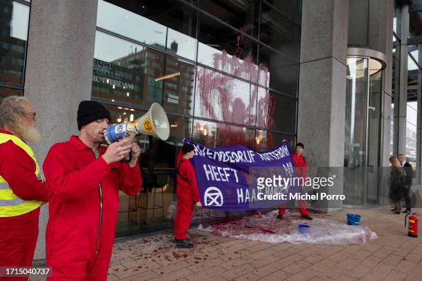 Protestors holding a banner reading 'Harbour Rotterdam has blood on her hands' have thrown red paint over the windows of the Rotterdam Harbour office...