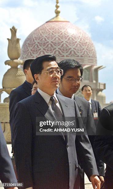 Chinese Vice President Hu Jintao arrives at the Malaysian Prime Minister Mahathir Mohamad's office with officials at Putrajaya, 35 kilometres south...