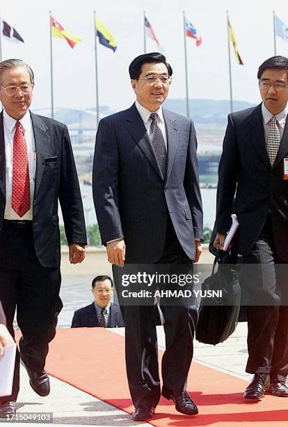 Chinese Vice President Hu Jintao arrives at the Malaysian Prime Minister Mahathir Mohamad's office with officials at Putrajaya, 35 kilometres south...