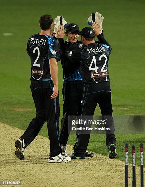 Tom Latham of New Zealand celebrates with team mates after running out Jos Buttler of England during the 1st Natwest International T20 match between...