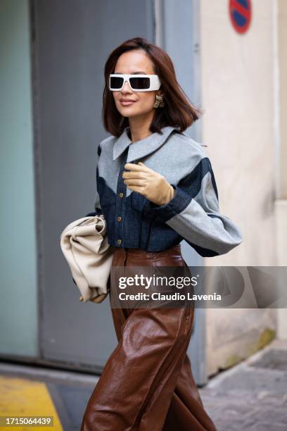 Anna Rosa Vitiello wears a denim crop jacket, brown leather pants, white sunglasses and beige tote bag, outside AZ Factory, during the Womenswear...