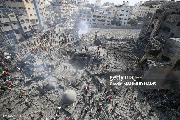 Palestinians inspect the damage following an Israeli airstrike on the Sousi mosque in Gaza City on October 9, 2023. Israel continued to battle Hamas...