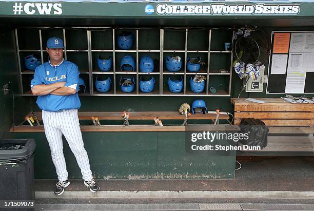 Head coach John Savage of the UCLA Bruins stands in the dugout before playing the Mississippi State Bulldogs during game two of the College World...