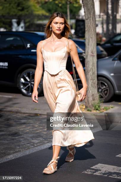 Chloe Lecareux wears a nude corset with matching maxi skirt, nude flat shoes and nude Chanel bag, outside Zimmermann, during the Womenswear...