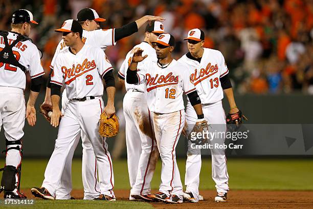 Alexi Casilla of the Baltimore Orioles celebrates with teammates after the Orioles defeated the Cleveland Indians 6-3 at Oriole Park at Camden Yards...