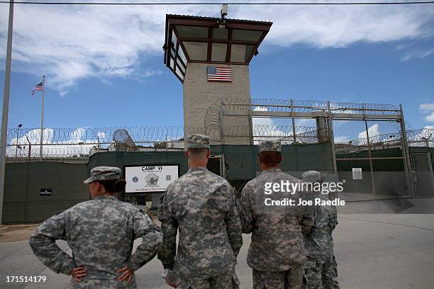 Military officers stand at the entrance to Camp VI and V at the U.S. Military prison for 'enemy combatants' on June 25, 2013 in Guantanamo Bay, Cuba....